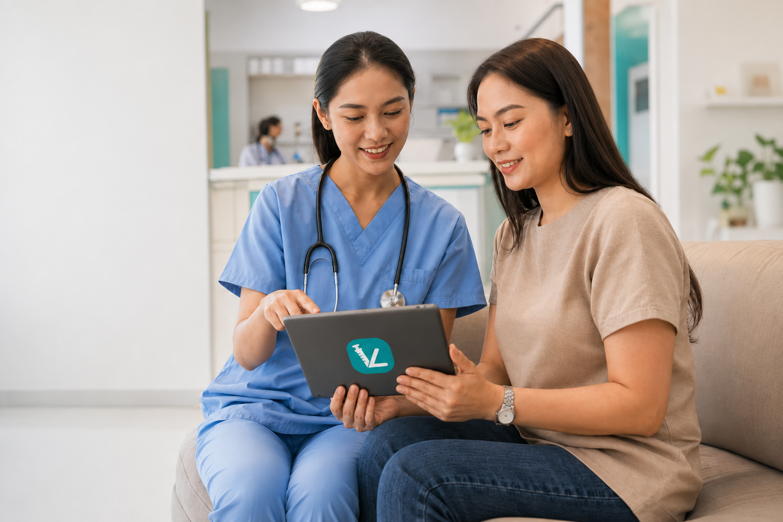 Filipino healthcare professional helping a patient review preventive-health information on a tablet